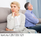 resentful middle-aged couple quarreling at home with each other. Стоковое фото, фотограф Яков Филимонов / Фотобанк Лори