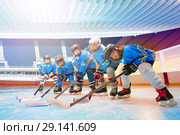 Children's hockey team line up on ice rink. Детская хоккейная команда на льду. Стоковое фото, фотограф Сергей Новиков / Фотобанк Лори