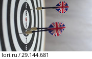 Lateral сlose up of playing darts on black-white dartboard. Стоковое видео, видеограф Uladzimir Sitkouski / Фотобанк Лори