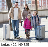 Family portrait of travellers with wheeled trollers in spring day. Стоковое фото, фотограф Яков Филимонов / Фотобанк Лори