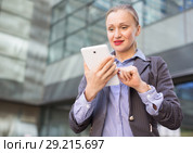 Female testing digital tablet in the modern city. Стоковое фото, фотограф Яков Филимонов / Фотобанк Лори