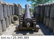 Old cast-iron cannon in a combat position. Russia, the Republic of Crimea, the city of Sevastopol. 12.06.2018: Reconstruction of the fortifications of the 4th bastion of the times of the Krymskiy War and the defense of Sevastopol. Стоковое фото, фотограф Вадим Орлов / Фотобанк Лори