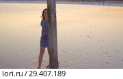 Calm girl enjoying sun, walking slowly through the water of a salt lake. Стоковое видео, видеограф Ирина Мойсеева / Фотобанк Лори