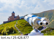 View point Binoscope directed towards to Gergeti Trinity Church Tsminda Sameba Holy Church near the village of Gergeti in Georgia. Стоковое фото, фотограф Алексей Ширманов / Фотобанк Лори
