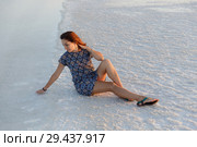 happy girl enjoying the sunset, touches water of a salt lake sitting on crystals. Стоковое фото, фотограф Ирина Мойсеева / Фотобанк Лори
