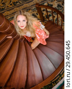 girl in silk robe stand on wooden spiral staircase. Стоковое фото, фотограф katalinks / Фотобанк Лори
