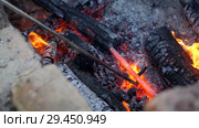 Blacksmith works metal. Craftsman, the Highlander on private smithy in the village. Burning logs in the blacksmith's furnace. Removing the preform from scorching hot crucible, using the poker. Slow motion. Стоковое видео, видеограф Константин Мерцалов / Фотобанк Лори