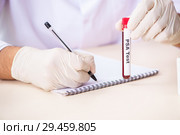 Young handsome lab assistant testing blood samples in hospital. Стоковое фото, фотограф Elnur / Фотобанк Лори