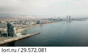 View from drone of Barceloneta beach with luxury hotel W Barcelona (2018 год). Стоковое видео, видеограф Яков Филимонов / Фотобанк Лори