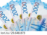 Новые купюры номиналом 2000 рублей крупным планом на белом фоне. Стоковое фото, фотограф Елена Коромыслова / Фотобанк Лори
