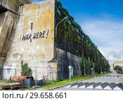 WW2: remains of the German Atlantic wall in Brittany. The U-boot base in Lorient. Here is the portrait of Eric Tabarly. (2017 год). Редакционное фото, фотограф Николай Коржов / Фотобанк Лори