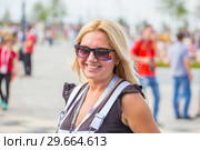Russia, Samara, June 2018: beautiful football cheerleader smiling at the World Cup. Редакционное фото, фотограф Акиньшин Владимир / Фотобанк Лори