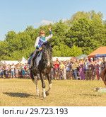 Russia, Samara, July, 2018: a Cossack girl rides a horse and performs tricks. Редакционное фото, фотограф Акиньшин Владимир / Фотобанк Лори