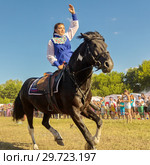 Russia, Samara, July, 2018: a Cossack girl rides a horse and performs tricks. Редакционное фото, фотограф Акиньшин Владимир / Фотобанк Лори