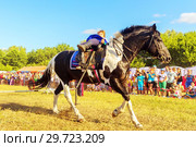 Russia, Samara, July, 2018: a Cossack girl rides a horse and performs tricks. Редакционное фото, фотограф Акиньшин Владимир / Фотобанк Лори