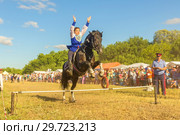 Russia, Samara, July, 2018: a Cossack girl rides a horse and performs tricks. Редакционное фото, фотограф Акиньшин Владимир / Фотобанк Лори