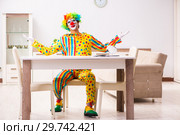 Male clown preparing for perfomance at home. Стоковое фото, фотограф Elnur / Фотобанк Лори
