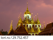 The top of Chedi Loha Prasat in the night illumination. Buddhist temple Wat Ratchanatdaram Woravihara , Bangkok (2018 год). Стоковое фото, фотограф Виктор Карасев / Фотобанк Лори