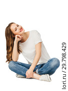 young cheerful girl in jeans, white t-shirt, sneakers sits on floor and smiles. isolated on white background. Стоковое фото, фотограф Евгения Филимонова / Фотобанк Лори