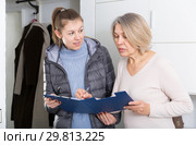 Female caseworker conducting survey. Стоковое фото, фотограф Яков Филимонов / Фотобанк Лори