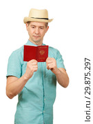 The man looks in the opened international passport. A look in a fullface. Стоковое фото, фотограф Владимир Арсентьев / Фотобанк Лори
