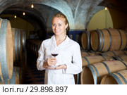 Female wine house worker checking quality of product. Стоковое фото, фотограф Яков Филимонов / Фотобанк Лори