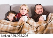 Sick parents and son under blanket. Стоковое фото, фотограф Яков Филимонов / Фотобанк Лори