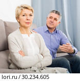 peeved mature couple quarreling at home with each other. Стоковое фото, фотограф Яков Филимонов / Фотобанк Лори