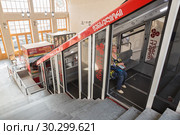 Mtatsminda Funicular in Tbilisi. Woman is sitting in the cable car waiting for departure (2018 год). Редакционное фото, фотограф Юлия Бабкина / Фотобанк Лори