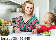woman and her daughter working with papers from home. Стоковое фото, фотограф Яков Филимонов / Фотобанк Лори