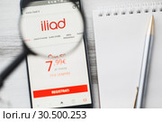 Los Angeles, California, USA - 3 April 2019: Iliad SA Telecommunication official website homepage under magnifying glass. Concept Iliad SA Telecommunication logo visible on smartphone, tablet screen. Редакционное фото, фотограф Сергей Тимофеев / Фотобанк Лори