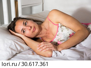 Cute adult woman in pygamas sleeping in bed in bedroom. Стоковое фото, фотограф Яков Филимонов / Фотобанк Лори