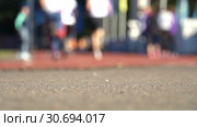 Blurred background of runners on stadium. Amateur sport footage slowmotion. Стоковое видео, видеограф Dmitry Domashenko / Фотобанк Лори
