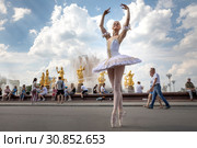Балерина во время репетиции у фонтана "Дружба народов" на ВДНХ во время фестиваля "Мировые балетные каникулы" в городе Москве, Россия (2019 год). Редакционное фото, фотограф Николай Винокуров / Фотобанк Лори