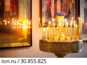 Large candlestick with burning candles in church. Стоковое фото, фотограф Дарья Трофимова / Фотобанк Лори