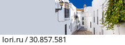 Horizontal cropped image with white copy space wall narrow street of Vejer de la Frontera spanish picturesque village, popular hilltop town municipality in province of Cadiz, Costa de la Luz, Spain (2013 год). Стоковое фото, фотограф Alexander Tihonovs / Фотобанк Лори