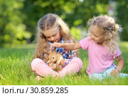 Girl with a cute little rabbit, outdoor, summer day. Стоковое фото, фотограф Чирцова Наталья / Фотобанк Лори