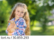 Girl with a cute little rabbit, outdoor, summer day. Стоковое фото, фотограф Чирцова Наталья / Фотобанк Лори