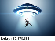 Flying saucer abducting young businessman. Стоковое фото, фотограф Elnur / Фотобанк Лори