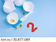 Long-awaited pregnancy after unsuccessful IVF. Positive pregnancy test, pills, eggshell and two. Стоковое фото, фотограф Papoyan Irina / Фотобанк Лори