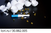Long-awaited pregnancy after unsuccessful IVF. Positive pregnancy test, pills, eggshell. Стоковое фото, фотограф Papoyan Irina / Фотобанк Лори