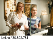 Girl with woman looking with interest at art objects in museum. Стоковое фото, фотограф Яков Филимонов / Фотобанк Лори