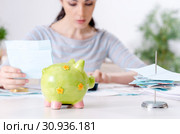 Young woman in budget planning concept. Стоковое фото, фотограф Elnur / Фотобанк Лори