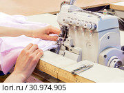 Industrial overlock sewing machine in work. Стоковое фото, фотограф Евгений Харитонов / Фотобанк Лори