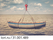 Rowing wooden boat is launching into the sea by using crane. Toned image. Стоковое фото, фотограф Олег Белов / Фотобанк Лори