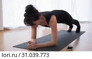 Barefoot woman n plank on arms is doing pilates programm at gym slow motion. Стоковое видео, видеограф Denis Mishchenko / Фотобанк Лори