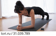 Barefoot woman n plank on arms is doing pilates programm at gym slow motion. Стоковое видео, видеограф Denis Mishchenko / Фотобанк Лори