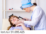 Young woman visiting female doctor otolaryngologist. Стоковое фото, фотограф Elnur / Фотобанк Лори