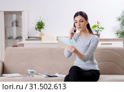 Young woman in budget planning concept. Стоковое фото, фотограф Elnur / Фотобанк Лори