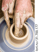 Potter's hands mold pottery on a rotating wheel. Стоковое фото, фотограф Евгений Харитонов / Фотобанк Лори